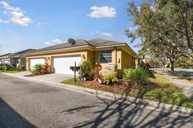 view of front of property featuring a garage, driveway, and stucco siding