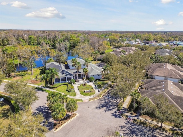 bird's eye view featuring a wooded view and a residential view