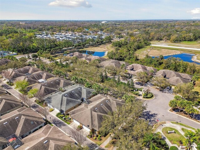 drone / aerial view with a residential view and a water view