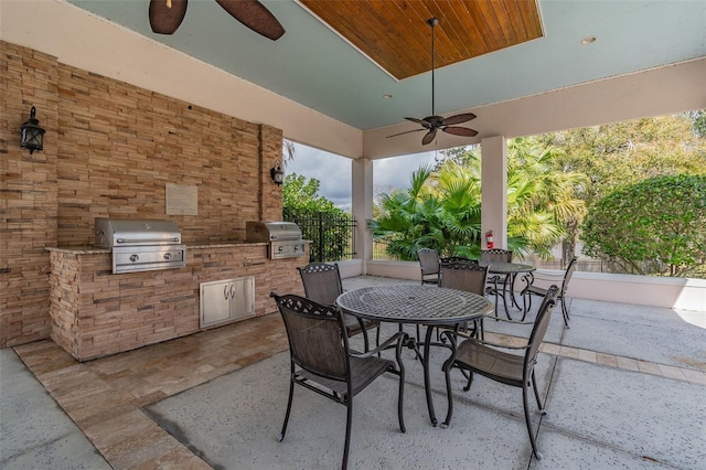 view of patio with a grill, a ceiling fan, area for grilling, and outdoor dining space