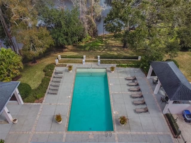 outdoor pool featuring a yard and a patio