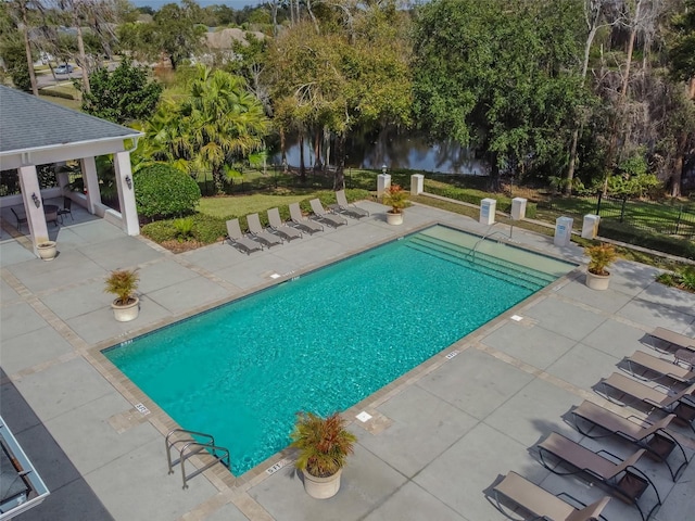 community pool featuring a yard, a patio area, fence, and a gazebo