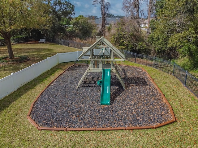 view of playground with a fenced backyard and a lawn