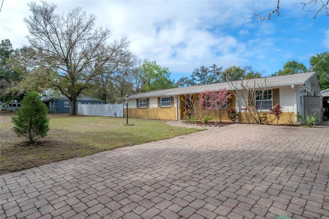 ranch-style home with fence, a front lawn, and brick siding