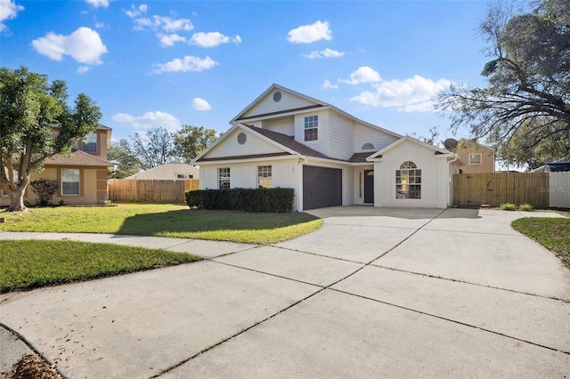 view of front of property with a front yard, concrete driveway, and fence