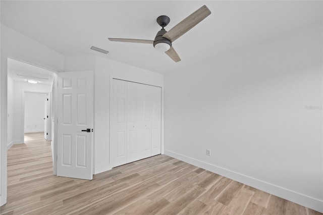 unfurnished bedroom with baseboards, visible vents, and light wood-style floors