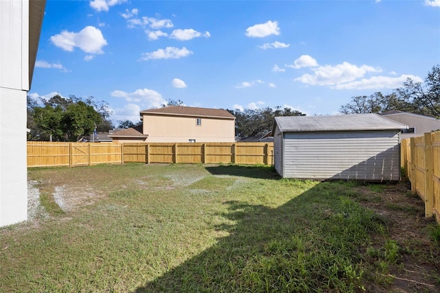 view of yard featuring a fenced backyard, an outdoor structure, and a storage unit