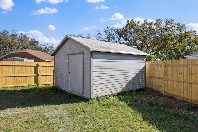 view of shed with a fenced backyard