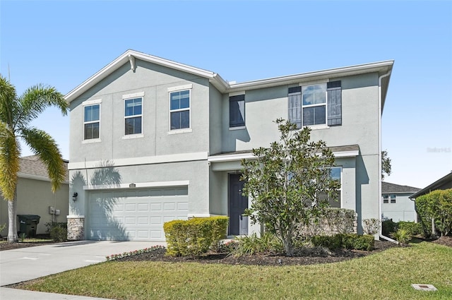 view of front of home featuring a garage, a front lawn, concrete driveway, and stucco siding