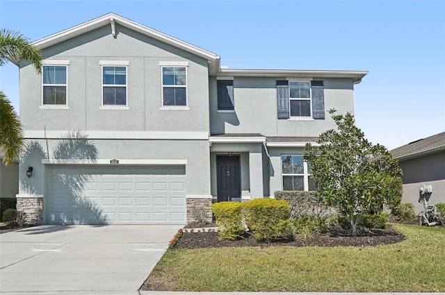 view of front of home with a garage, stone siding, driveway, and stucco siding