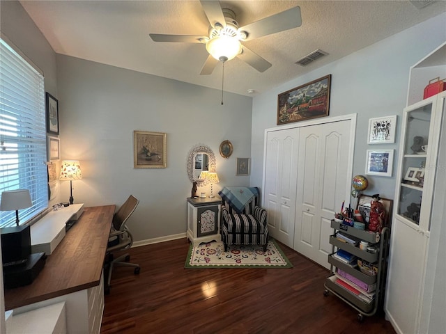 office space featuring baseboards, visible vents, ceiling fan, wood finished floors, and a textured ceiling