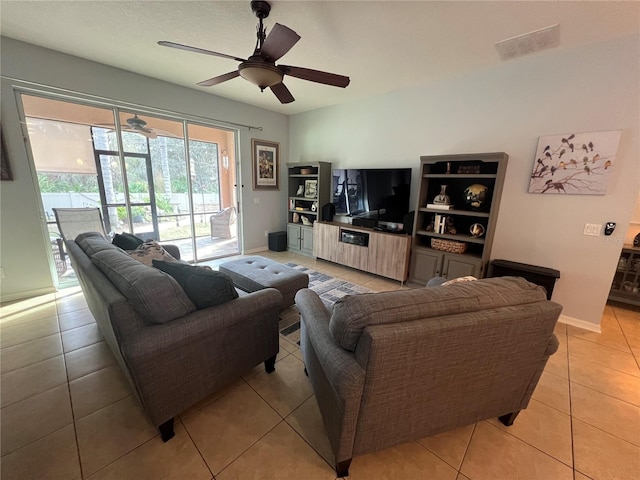 living area with visible vents, ceiling fan, baseboards, and light tile patterned floors