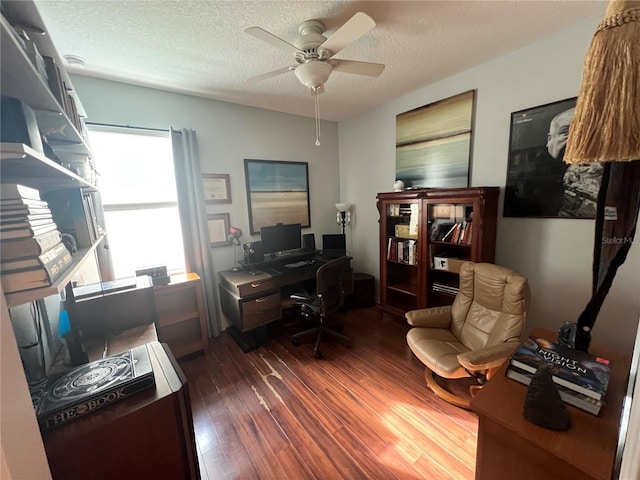 home office with dark wood-style floors, a textured ceiling, and a ceiling fan