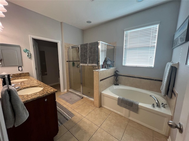 bathroom with double vanity, a bath, tile patterned flooring, a shower stall, and a sink