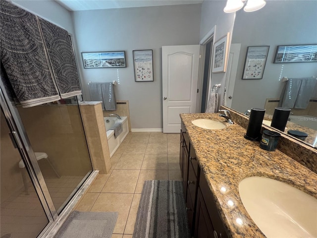 full bath with double vanity, a sink, a bath, and tile patterned floors