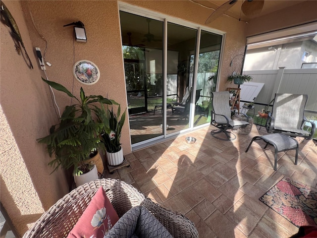 sunroom / solarium with ceiling fan