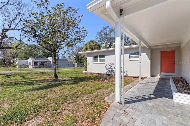 view of yard featuring fence and a patio