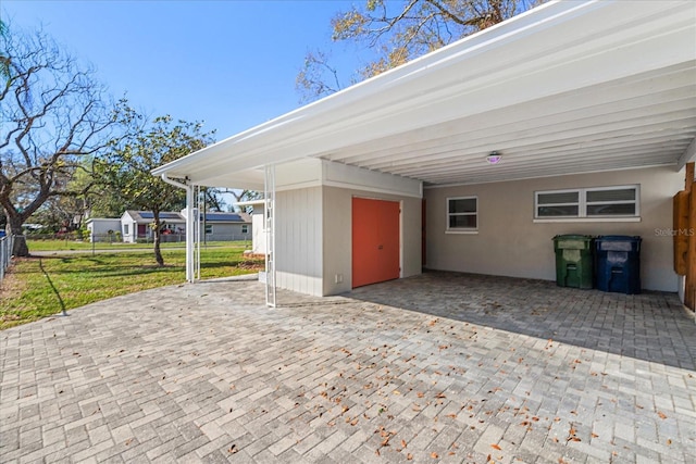 exterior space featuring a carport and fence