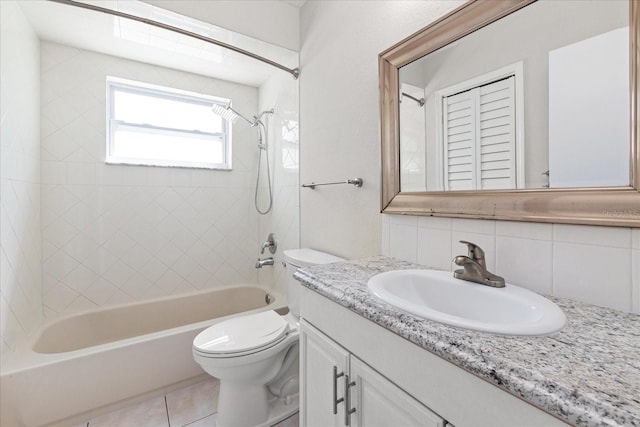 full bath featuring shower / tub combination, toilet, vanity, decorative backsplash, and tile patterned floors