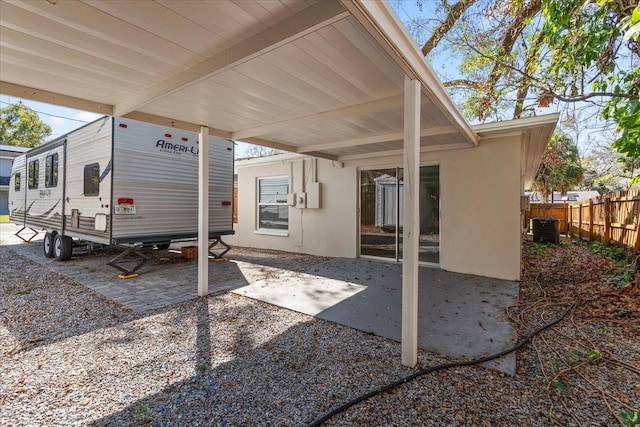 view of patio with fence and central air condition unit