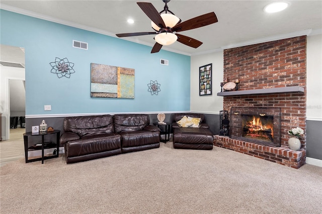 carpeted living room featuring ornamental molding, recessed lighting, a brick fireplace, and visible vents