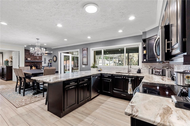 kitchen with decorative backsplash, dishwasher, stainless steel microwave, light stone countertops, and a sink