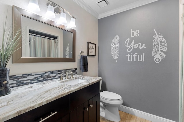 full bath with toilet, vanity, visible vents, decorative backsplash, and crown molding