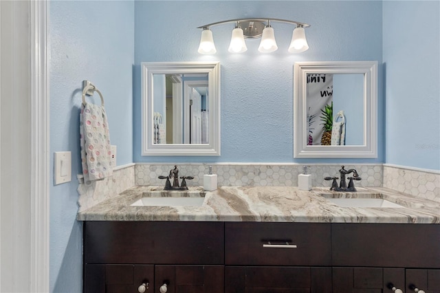 full bath with double vanity and a sink