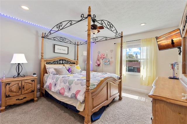 bedroom featuring light carpet, a textured ceiling, baseboards, and recessed lighting