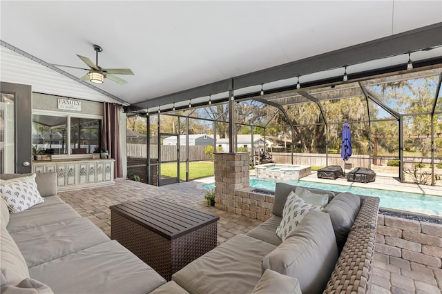 sunroom / solarium with lofted ceiling and a ceiling fan