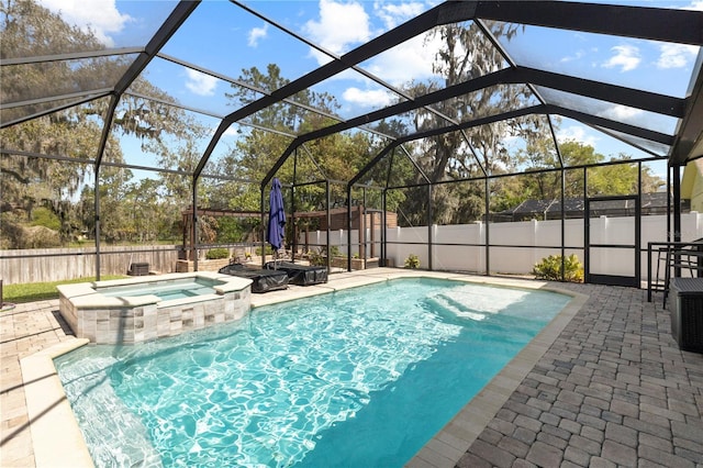 view of pool with a patio area, a fenced backyard, and a pool with connected hot tub