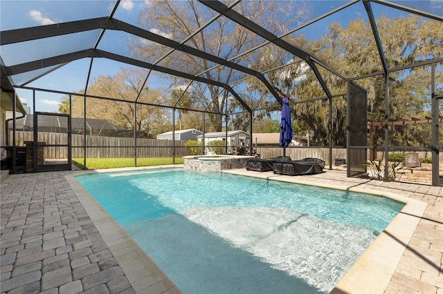 view of pool with glass enclosure, a fenced backyard, and a patio