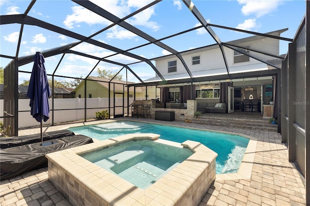 view of swimming pool featuring outdoor dry bar, a patio, a lanai, and a pool with connected hot tub