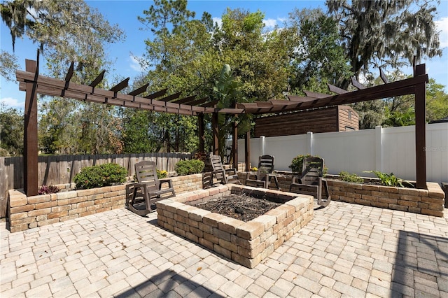 view of patio with a fenced backyard, a fire pit, and a pergola