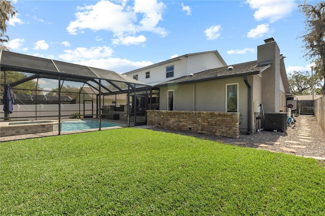 rear view of property featuring a fenced in pool, a lawn, glass enclosure, a fenced backyard, and central AC