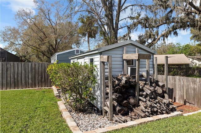 view of outdoor structure with an outbuilding and a fenced backyard