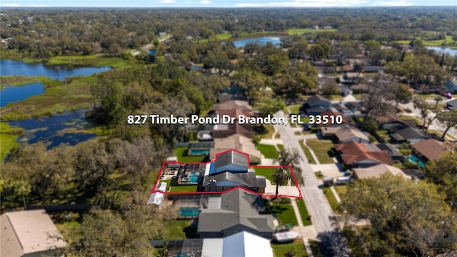 drone / aerial view featuring a water view and a forest view