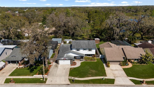 bird's eye view with a wooded view