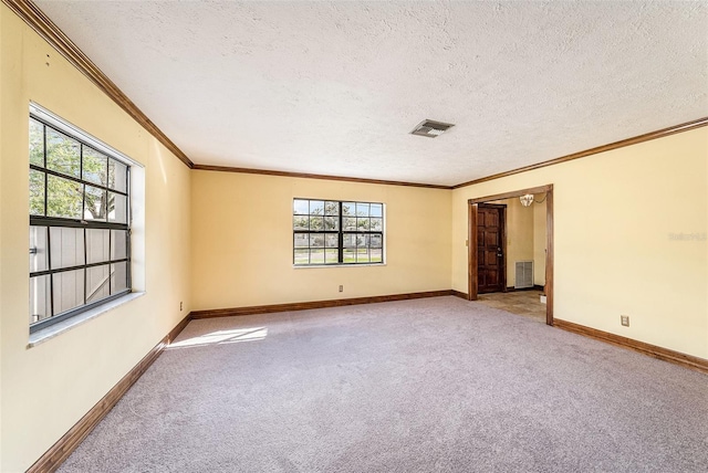 carpeted spare room featuring a textured ceiling, visible vents, and baseboards