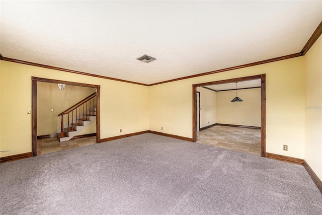 empty room with crown molding, visible vents, stairway, light carpet, and baseboards