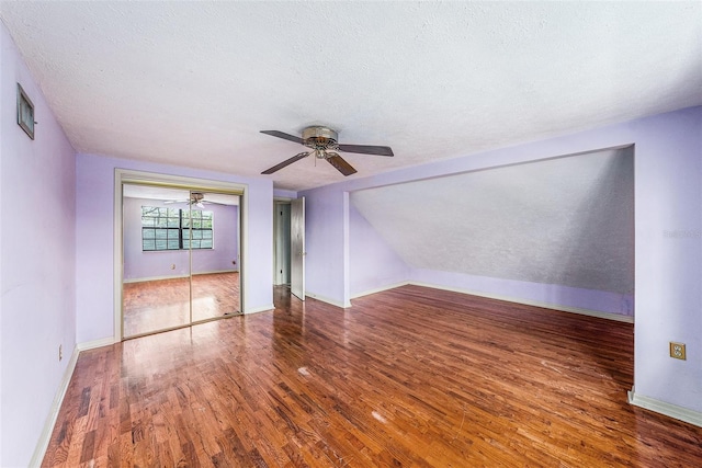 interior space featuring baseboards, visible vents, ceiling fan, wood finished floors, and a textured ceiling