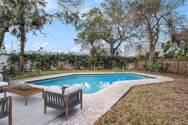 view of pool with a patio area, a fenced backyard, and a fenced in pool