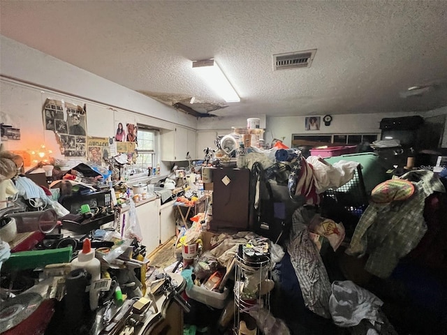 miscellaneous room featuring visible vents and a textured ceiling