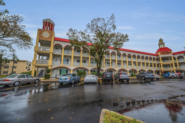 view of building exterior with uncovered parking