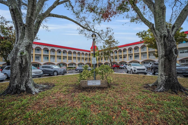 view of building exterior with uncovered parking