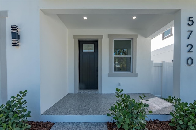 view of exterior entry featuring stucco siding