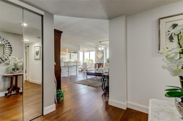 hall featuring baseboards and wood finished floors