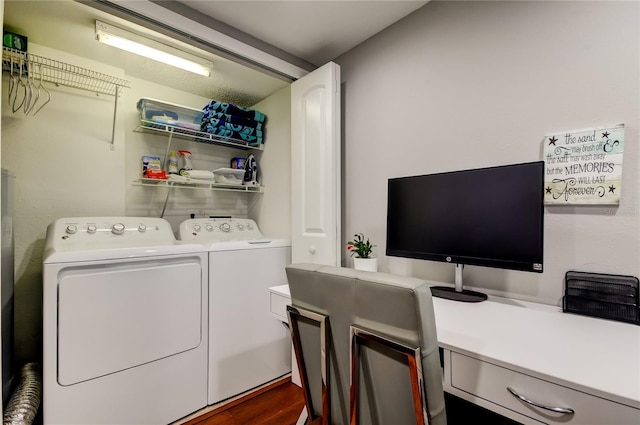 clothes washing area with laundry area, washing machine and clothes dryer, and wood finished floors