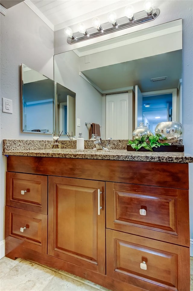 bathroom featuring crown molding and vanity