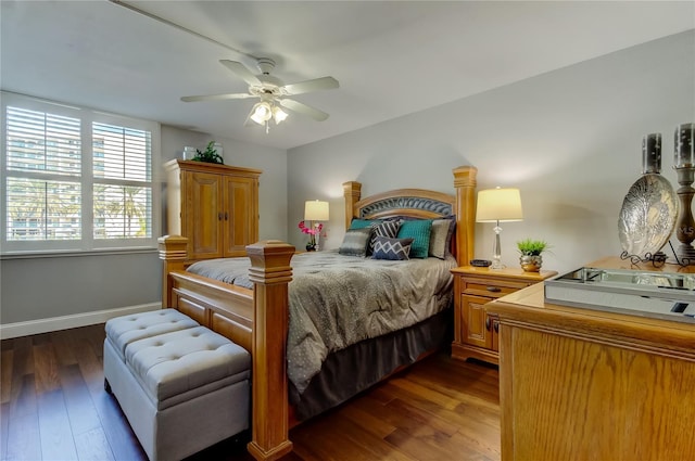 bedroom with ceiling fan, dark wood-style flooring, and baseboards